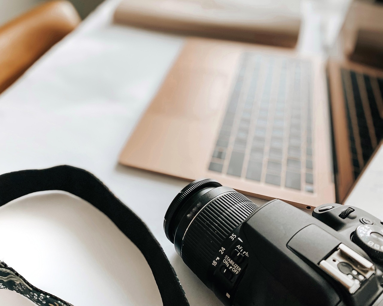 Laptop, camera, desk — Why Digital tranformation is important for every Buisness in 2022